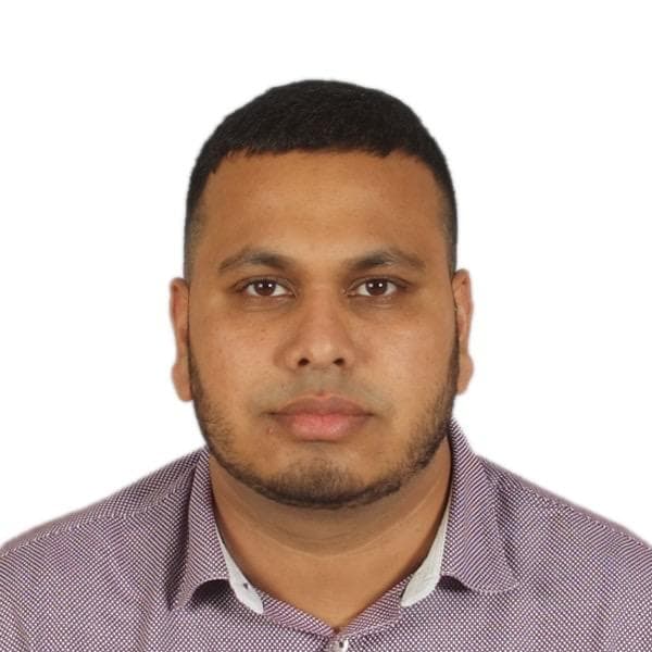 Headshot of a man with short hair and a beard wearing a purple patterned shirt.